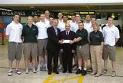 6 July 2005; Sponsors of the Ireland Men's U20 team, MSL, (Motor Services Limited), represented by Group Operations Manager Brendan Grace presents a cheque to Alan Keenan, centre, and Mark Keenan, right, of Basketball Ireland, in the presence of the Ireland Men's U20 team, in Dublin airport prior to the teams departure for the Men's U20 European championships in Varna, Bulgaria. Dublin Airport, Dublin. Picture credit; Pat Murphy / SPORTSFILE