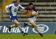 9 July 2005; Padraig Curtis, Wexford, is tackled by James McElroy, Monaghan. Bank of Ireland All-Ireland Senior Football Championship Qualifier, Round 2, Monaghan v Wexford, St. Tighernach's Park, Clones, Co. Monaghan. Picture credit; Pat Murphy / SPORTSFILE