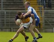 9 July 2005; Diarmuid Kinsella, Wexford, is tackled by Dick Clerkin, Monaghan. Bank of Ireland All-Ireland Senior Football Championship Qualifier, Round 2, Monaghan v Wexford, St. Tighernach's Park, Clones, Co. Monaghan. Picture credit; Pat Murphy / SPORTSFILE