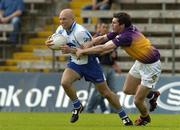 9 July 2005; Nicholas Corrigan, Monaghan, is tackled by David Murphy, Wexford. Bank of Ireland All-Ireland Senior Football Championship Qualifier, Round 2, Monaghan v Wexford, St. Tighernach's Park, Clones, Co. Monaghan. Picture credit; Pat Murphy / SPORTSFILE