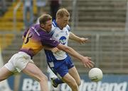 9 July 2005; Eoin Lennon, Monaghan, is tackled by Nicky Lambert, Wexford. Bank of Ireland All-Ireland Senior Football Championship Qualifier, Round 2, Monaghan v Wexford, St. Tighernach's Park, Clones, Co. Monaghan. Picture credit; Pat Murphy / SPORTSFILE