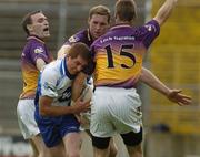 9 July 2005; Tomas Freeman, Monaghan, is tackled by Wexford players Colm Morris, left, Nicky Lambert, centre, and Matty Forde. Bank of Ireland All-Ireland Senior Football Championship Qualifier, Round 2, Monaghan v Wexford, St. Tighernach's Park, Clones, Co. Monaghan. Picture credit; Pat Murphy / SPORTSFILE