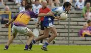 9 July 2005; Stephen Gollogly, Monaghan, is tackled by Padraig Curtis, Wexford. Bank of Ireland All-Ireland Senior Football Championship Qualifier, Round 2, Monaghan v Wexford, St. Tighernach's Park, Clones, Co. Monaghan. Picture credit; Pat Murphy / SPORTSFILE
