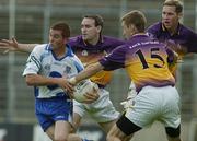 9 July 2005; Tomas Freeman, Monaghan, is tackled by Wexford players Colm Morris, left, Nicky Lambert, right, and Matty Forde. Bank of Ireland All-Ireland Senior Football Championship Qualifier, Round 2, Monaghan v Wexford, St. Tighernach's Park, Clones, Co. Monaghan. Picture credit; Pat Murphy / SPORTSFILE