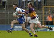 9 July 2005; Colm Flanagan, Monaghan, is tackled by Nicky Lambert, Wexford. Bank of Ireland All-Ireland Senior Football Championship Qualifier, Round 2, Monaghan v Wexford, St. Tighernach's Park, Clones, Co. Monaghan. Picture credit; Pat Murphy / SPORTSFILE