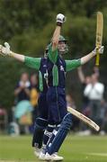 9 July 2005; Ireland's Andrew White celebrates with team-mate Peter Gillespie, hidden, after hitting a six to win the game in the final over. ICC Trophy Semi-Final, Ireland v Canada, Castle Avenue, Clontarf, Dublin. Picture credit; Brian Lawless / SPORTSFILE