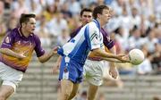 9 July 2005; Raymond Ronaghan, Monaghan, in action against Padraig Curtis, Wexford. Bank of Ireland All-Ireland Senior Football Championship Qualifier, Round 2, Monaghan v Wexford, St. Tighernach's Park, Clones, Co. Monaghan. Picture credit; Pat Murphy / SPORTSFILE