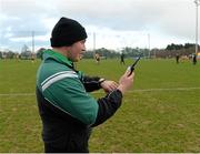 21 February 2014; Kieran Treanor, fourth official, tests the GAA's new clock / hooter system, which is being used for the first time this weekend, on a trial basis, in the Irish Daily Mail Sigerson Cup semi-finals and final hosted by Queen's University, Belfast. The Dub, Queen's University, Belfast, Co. Antrim. Picture credit: Oliver McVeigh / SPORTSFILE
