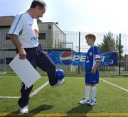 12 July 2005; Republic of Ireland manager Brian Kerr practices his ball control with 7 year old Gary O'Connor, winner of the FAI Pepsi Summer Soccer School Dream Prize to train with Real Madrid's David Beckham in London. Templeogue FC, Tymon Park, Templeogue, Dublin. Picture credit; Pat Murphy / SPORTSFILE
