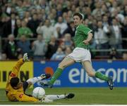 11 June 2003; Republic of Ireland's Robbie Keane slides the ball past Georgian goalkeeper George Lomaia to score his side's second goal. 2004 European Championship Qualifier, Republic of Ireland v Georgia, Lansdowne Road, Dublin. Picture credit; Pat Murphy / SPORTSFILE