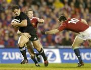 9 July 2005; Rico Gear, New Zealand, is tackled by Dwayne Peel, and Stephen Jones, British and Irish Lions. British and Irish Lions Tour to New Zealand 2005, 3rd Test, New Zealand v British and Irish Lions, Eden Park, Auckland, New Zealand. Picture credit; Brendan Moran / SPORTSFILE