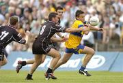 17 July 2005; Peter O'Dwyer, Clare, is tackled by Sean Davy, Dara McGarty, back, and Mark Breheny, 11, Sligo. Bank of Ireland All-Ireland Senior Football Championship Qualifier, Round 3, Sligo v Clare, McHale Park, Castlebar, Co. Mayo. Picture credit; Pat Murphy / SPORTSFILE