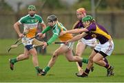 23 February 2014; Dan Currams, Offaly, in action against Matthew O'Hanlon, Wexford. Allianz Hurling League Division 1B Round 2, Wexford v Offaly, O'Kennedy Park, New Ross, Co. Wexford. Picture credit: Matt Browne / SPORTSFILE