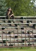 14 July 2005; A member of the armed forces watches the match. UEFA Cup, First Qualifying Round, First Leg, FK Ekranas v Cork City, Aukstaitija, Panevezys, Lithuania. Picture credit; Brian Lawless / SPORTSFILE