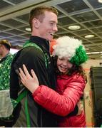 25 February 2014; Team Ireland's Conor Lyne receives a hug from his cousin Siobhan Lyne, aged 10, from Brandon, Co. Kerry, on his return from the Sochi 2014 Winter Olympic Games in Russia. Dublin Airport, Dublin. Photo by Sportsfile