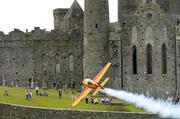21 July 2005; Pilot Frank Versteegh, Holland, in his Extra 330L aircraft, flies by the Rock of Cashel, during the pilots practice run in advance of Sunday's Red Bull Air Race. Cashel, Co. Tipperary. Picture credit; David Maher / SPORTSFILE