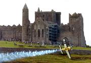 21 July 2005; Pilot Steve Jones, UK, in his Extra 330S aircraft, flies by the Rock of Cashel, during the pilots practice run in advance of Sunday's Red Bull Air Race. Cashel, Co. Tipperary. Picture credit; David Maher / SPORTSFILE