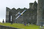 21 July 2005; Pilot Peter Besenyei, Hungary, in his Extra 330S aircraft, flies by the Rock of Cashel, during the pilots practice run in advance of Sunday's Red Bull Air Race. Cashel, Co. Tipperary. Picture credit; David Maher / SPORTSFILE