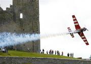 21 July 2005; Pilot Mike Mangold, USA, in his Edge 540 aircraft, flies by the Rock of Cashel, during the pilots practice run in advance of Sunday's Red Bull Air Race. Cashel, Co. Tipperary. Picture credit; David Maher / SPORTSFILE