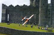 21 July 2005; Pilot Nicolas Ivanoff, France, in his Extra 230 aircraft, flies by the Rock of Cashel, during the pilots practice run in advance of Sunday's Red Bull Air Race. Cashel, Co. Tipperary. Picture credit; David Maher / SPORTSFILE