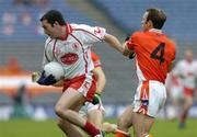 23 July 2005; Ryan Mellon, Tyrone, is tackled by Enda McNulty, Armagh. Bank of Ireland Ulster Senior Football Championship Final Replay, Tyrone v Armagh, Croke Park, Dublin. Picture credit; Matt Browne / SPORTSFILE