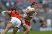 23 July 2005; Brian McGuigan, Tyrone, is tackled by Kieran McGeeney, Armagh. Bank of Ireland Ulster Senior Football Championship Final Replay, Tyrone v Armagh, Croke Park, Dublin. Picture credit; Matt Browne / SPORTSFILE