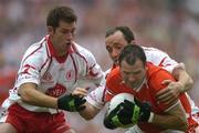 23 July 2005; Steven McDonnell, Armagh, is tackled by Shane Sweeney, left, and Brian Dooher, Tyrone. Bank of Ireland Ulster Senior Football Championship Final Replay, Tyrone v Armagh, Croke Park, Dublin. Picture credit; Brendan Moran / SPORTSFILE