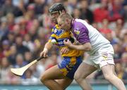 24 July 2005; Damien Fitzhenry, Wexford goalkeeper, is tackled by Tony Carmody, Clare. Guinness All-Ireland Senior Hurling Championship Quarter-Final, Wexford v Clare, Croke Park, Dublin. Picture credit; Damien Eagers / SPORTSFILE
