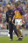 24 July 2005; Wexford's Declan Ruth walks off the pitch after picking up an injury with Wexford team doctor Stephen Bowe. Guinness All-Ireland Senior Hurling Championship Quarter-Final, Wexford v Clare, Croke Park, Dublin. Picture credit; Damien Eagers / SPORTSFILE