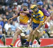 24 July 2005; Tony Griffin, Clare, in action against David O'Connor and Diarmuid Lyng, Wexford. Guinness All-Ireland Senior Hurling Championship Quarter-Final, Wexford v Clare, Croke Park, Dublin. Picture credit; Brendan Moran / SPORTSFILE