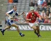 24 July 2005; Niall McCarthy, Cork, in action against Eoin Kelly, Waterford. McCarthy's boots are displaying an advertisement for an alcoholic beverage. Guinness All-Ireland Senior Hurling Championship Quarter-Final, Cork v Waterford, Croke Park, Dublin. Picture credit; Brendan Moran / SPORTSFILE