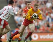23 July 2005; Pascal McConnell, Tyrone, is tackled by Oisin McConville, Armagh. Bank of Ireland Ulster Senior Football Championship Final Replay, Tyrone v Armagh, Croke Park, Dublin. Picture credit; Brendan Moran / SPORTSFILE