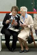 25 July 2005; Two race fans check the form before the first race. Galway Races, Ballybrit, Co. Galway. Picture credit; Pat Murphy / SPORTSFILE