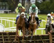 25 July 2005; Mahdi De Coeur, with Philip Carberry up, left, jumps the last alongside Thunder Road, with Ruby Walsh up, on their way to winning the G.P.T. Dublin Handicap Hurdle. Galway Races, Ballybrit, Co. Galway. Picture credit; Pat Murphy / SPORTSFILE