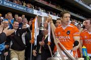 23 July 2005; Paul McGrane, Armagh lifts the Anglo Celt cup with injured teammate John Toal, left as Armagh captain Kieran McGeeney looks on. Bank of Ireland Ulster Senior Football Championship Final Replay, Tyrone v Armagh, Croke Park, Dublin. Picture credit; Damien Eagers / SPORTSFILE