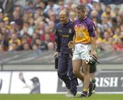 24 July 2005; Declan Ruth, Wexford walks off the field injured with team doctor Stephen Bowe. Guinness All-Ireland Senior Hurling Championship Quarter-Final, Wexford v Clare, Croke Park, Dublin. Picture credit; Damien Eagers / SPORTSFILE