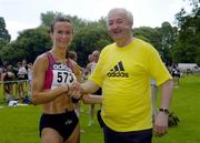 10 July 2005; Editor of the Irish Runner Frank Greally congratulates Pauline Curley, Tullamore Harriers, after she was the first woman home in the adidas Irish Runner Challenge. Phoenix Park, Dublin.. Picture credit; Brian Lawless / SPORTSFILE