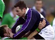 18 February 2000; Derrick Lee, Scotland A, holds off the tackle of Eric Miller, Ireland A. Six Nations &quot;A&quot; Rugby International, Ireland A v Scotland A, Donnybrook, Dublin. Picture credit: Brendan Moran / SPORTSFILE