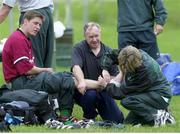 8 January 2000; Ireland's Ronan O'Gara receives treatment for an ankle injury during training, from rugby team physiotherapist Denise Fanagan, right, and masseur Willie Bennett. Ireland Rugby Squad Training, Toronto, Ontario, Canada. Picture credit: Matt Browne / SPORTSFILE
