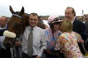 27 July 2005; Winning jockey Denis O'Regan is congratulated by owner Kay Devlin, watched by trainer Dermot Weld, right, after Ansar had won the Hewlett-Packard Galway Plate. Galway Races, Ballybrit, Co. Galway. Picture credit; Pat Murphy / SPORTSFILE