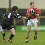 30 July 2005; Conor McCarthy, Cork, is tackled by Brendan Egan, Sligo. Bank of Ireland Football Championship qualifiers, Round 4. Cork v Sligo, O'Moore Park, Portlaoise, Co. Laois. Picture credit; Brendan Moran / SPORTSFILE