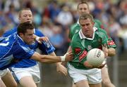 30 July 2005; Gary Ruane of Mayo is tackled by Finbar O'Reilly of Cavan during the GAA All-Ireland Football Championship Qualifer, Round 4 match between Mayo and Cavan at Dr Hyde Park in Roscommon. Photo by Matt Browne/Sportsfile