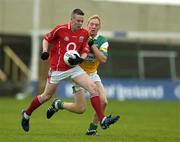 30 July 2005; Sean Kiely, Cork is tackled by Stephen Lonergan, Offaly. All-Ireland Minor Football Championship Quarter Final, Cork v Offaly, O'Moore Park, Portlaoise, Co. Laois. Picture credit; Brendan Moran / SPORTSFILE