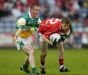 30 July 2005; David Gould, Cork is tackled by Rory Connor, Offaly. All-Ireland Minor Football Championship Quarter Final, Cork v Offaly, O'Moore Park, Portlaoise, Co. Laois. Picture credit; Brendan Moran / SPORTSFILE