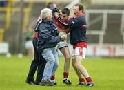 30 July 2005; Cork's Donncha O'Connor, centre, celebrates with team-mate Vincent Hurley, right, and two team officials after the final whistle. All-Ireland Junior Football Final, Cork v Meath, O'Moore Park, Portlaoise, Co. Laois. Picture credit; Brendan Moran / SPORTSFILE