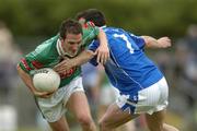 30 July 2005; Alan Dillon, Mayo, is tackled by Peter Reilly, Cavan. Bank of Ireland Football Championship qualifer, Round 4. Mayo v Cavan, Dr. Hyde Park, Roscommon. Picture credit; Matt Browne / SPORTSFILE