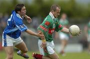30 July 2005; Marty McNicholas, Mayo, is tackled by Michael Hannon, Cavan. Bank of Ireland Football Championship qualifer, Round 4. Mayo v Cavan, Dr. Hyde Park, Roscommon. Picture credit; Matt Browne / SPORTSFILE