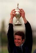 24 April 1999; Cork Church of Ireland captain Nigel Buttimer lifts the cup after the Nissan Irish Senior Men's Hockey Cup Final match between Cork Church of Ireland and Three Rock Rovers at the National Hockey Stadium in Belfield, Dublin. Photo by David Maher/Sportsfile