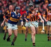28 March 1999; Peter Barry of Kilkenny in action against Paul Kelly of Tipperary during the Church and General National Hurling League Division 1B match between Kilkenny and Tipperary at Nowlan Park in Kilkenny. Photo by Matt Browne/Sportsfile