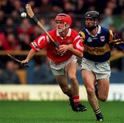 4 April 1999; Sean McGrath of Cork in action against Thomas Dunne of Tipperary during the Church & General National Hurling League Division 1B match between Tipperary and Cork at Semple Stadium in Thurles, Tipperary. Photo by Brendan Moran/Sportsfile